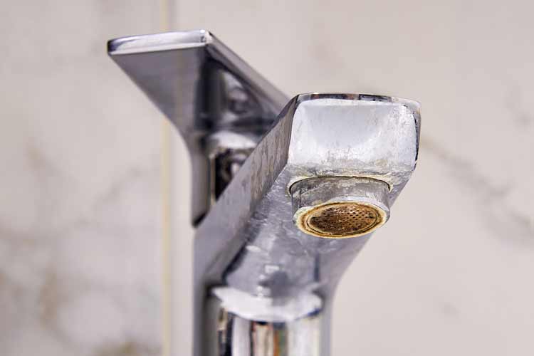 Close-up of a faucet with hard water buildup