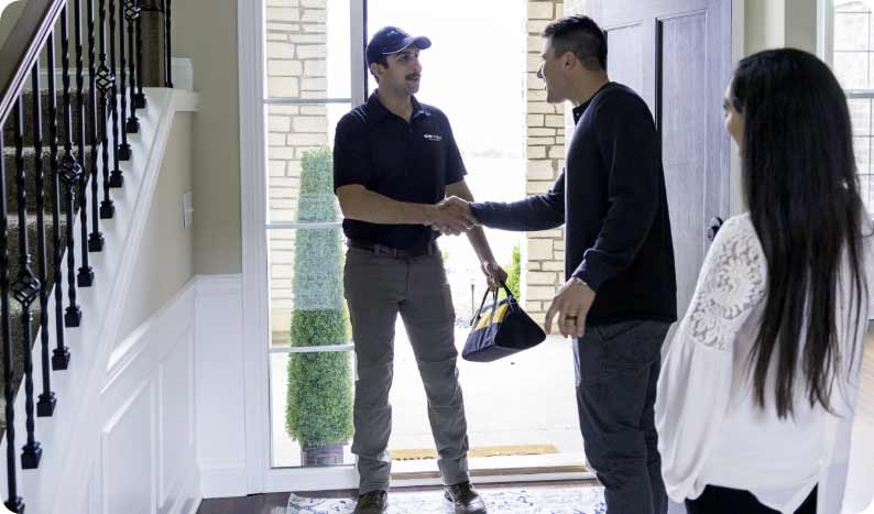 Kinetico technician greeting homeowners at their front door