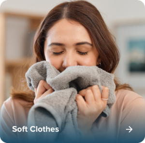 Woman enjoying the softness of clothes washed with Dooley's softened water